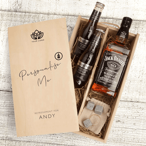 A personalised Gift box filled with two bottles of Fever Tree Cola, a bottle of Jack Daniels, and 3 whiskey cubs on top of a beige bag