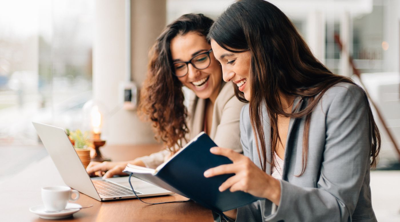 Image of two business women in corporate setting