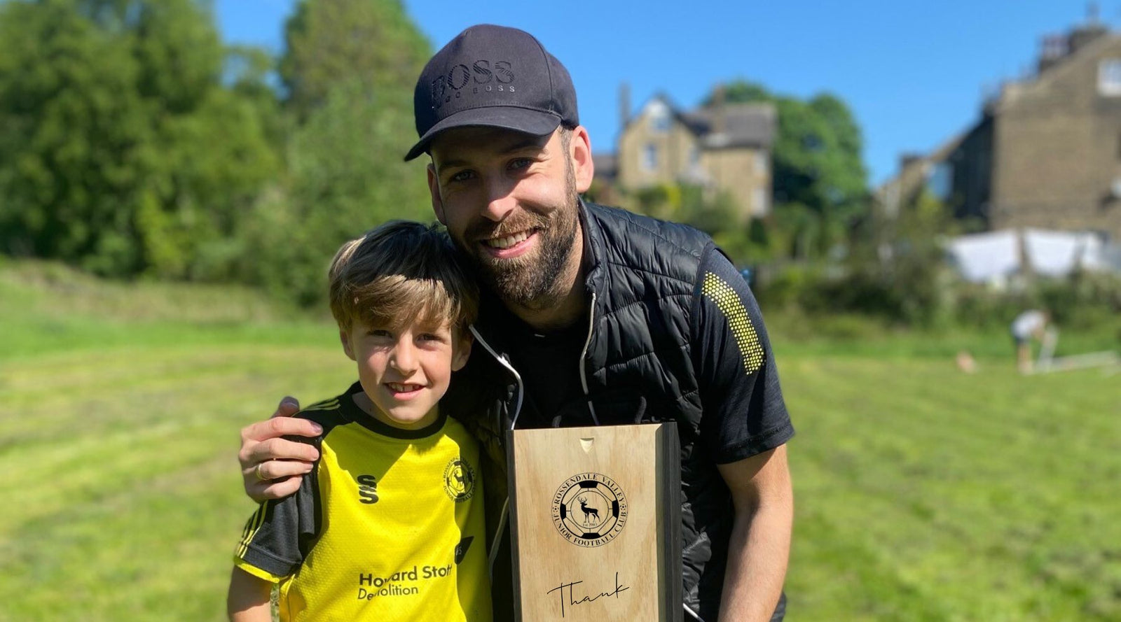 Football coach and player holding gift for coach