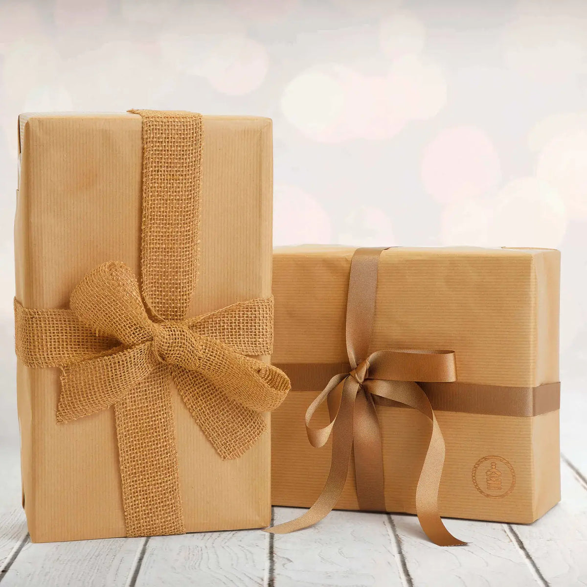 Fathers day gift set wrapped up in brown wrapping paper, and tied with brown ribbons tied in a bow around it.